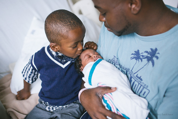 brother kissing baby in orlando hospital newborn photos