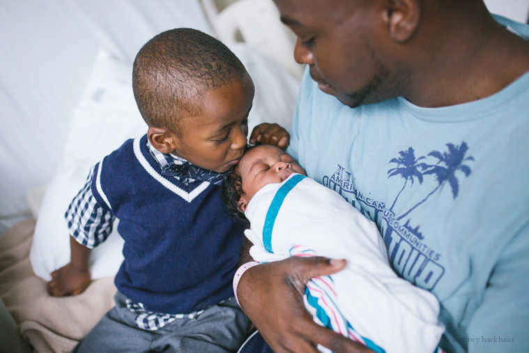 brother kissing baby in orlando hospital newborn photos